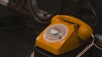 a yellow telephone sitting on top of a table