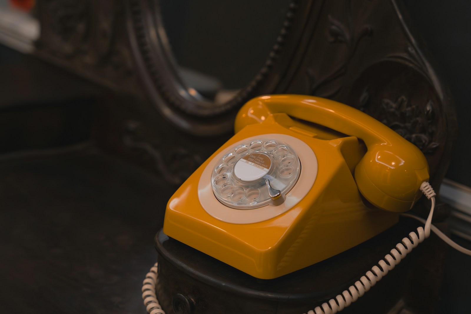 a yellow telephone sitting on top of a table